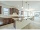 Spacious kitchen with dark wood cabinets, granite countertops, a large center island, and stainless steel appliances at 10609 E Durant Dr, Mesa, AZ 85212