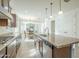 Bright and open kitchen with granite counters, stainless appliances, and a view into the dining area at 10609 E Durant Dr, Mesa, AZ 85212