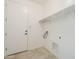 Laundry room with tile floor, shelving, and utility connections at 10609 E Durant Dr, Mesa, AZ 85212
