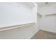 Walk-in closet featuring built in shelving and neutral carpet at 10609 E Durant Dr, Mesa, AZ 85212
