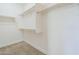 Walk-in closet featuring built in shelving and neutral carpet at 10609 E Durant Dr, Mesa, AZ 85212
