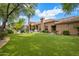 Sprawling backyard with manicured lawn, covered patio, and ample space for outdoor activities at 10892 E Gold Dust Ave, Scottsdale, AZ 85259