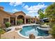 Resort-style backyard with a sparkling pool, spa, and ample patio space for entertaining at 10892 E Gold Dust Ave, Scottsdale, AZ 85259