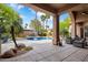 Resort style backyard featuring a covered patio, a sparkling pool, and desert landscaping at 10892 E Gold Dust Ave, Scottsdale, AZ 85259