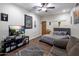 Comfortable bedroom with hardwood floors, and a cozy gray sofa, featuring a large flat screen television at 10892 E Gold Dust Ave, Scottsdale, AZ 85259