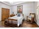 Cozy bedroom featuring hardwood floors, a charming rocking chair, and a unique diamond patterned accent wall at 10892 E Gold Dust Ave, Scottsdale, AZ 85259