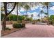 Beautiful brick gated entry to a residential community with mature trees and landscaping at 10892 E Gold Dust Ave, Scottsdale, AZ 85259