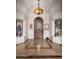 Elegant foyer featuring custom tile flooring, arched wood door, and recessed display nooks with western movie posters at 10892 E Gold Dust Ave, Scottsdale, AZ 85259