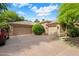 Spacious three-car garage with a wide driveway and manicured landscaping at 10892 E Gold Dust Ave, Scottsdale, AZ 85259