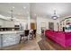 Open kitchen and living area with bar seating and stainless steel appliances at 10892 E Gold Dust Ave, Scottsdale, AZ 85259