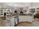 Gourmet kitchen with granite countertops and adjacent open plan living space at 10892 E Gold Dust Ave, Scottsdale, AZ 85259