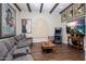Inviting living room with hardwood floors, exposed wood beams, and a comfortable gray sectional sofa at 10892 E Gold Dust Ave, Scottsdale, AZ 85259