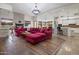 Open-concept living room with a stone fireplace, hardwood floors, and elegant lighting at 10892 E Gold Dust Ave, Scottsdale, AZ 85259