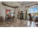 Open concept living area with coffered ceilings, an antique cabinet, and views of the sparkling pool at 10892 E Gold Dust Ave, Scottsdale, AZ 85259