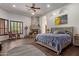Main bedroom showcasing hardwood floors, a stone fireplace, and neutral decor at 10892 E Gold Dust Ave, Scottsdale, AZ 85259