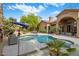 Inviting pool and spa with comfortable seating, lush landscaping, and a private backyard oasis at 10892 E Gold Dust Ave, Scottsdale, AZ 85259