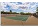 Well maintained community tennis court on a sunny day with nice landscaping and privacy fence at 10892 E Gold Dust Ave, Scottsdale, AZ 85259
