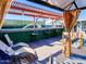 Backyard with a covered pergola featuring a bar, seating, and a pool with artificial turf surround at 11215 N 37Th Ave, Phoenix, AZ 85029
