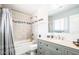 Modern bathroom featuring sleek vanity, granite counters, tiled shower and tub with glass enclosure at 11215 N 37Th Ave, Phoenix, AZ 85029