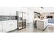 Modern kitchen featuring stainless steel appliances, and island with seating and tile backsplash at 11215 N 37Th Ave, Phoenix, AZ 85029