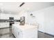 Bright, fully equipped kitchen with stainless steel appliances, quartz countertops, and eat-in island with pendant lighting at 11215 N 37Th Ave, Phoenix, AZ 85029