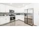 Modern kitchen featuring stainless steel appliances, sleek white cabinets, stylish backsplash and quartz countertops at 11215 N 37Th Ave, Phoenix, AZ 85029