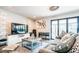 Bright living room with a large TV, modern shelving, comfortable seating and a sliding glass door at 11215 N 37Th Ave, Phoenix, AZ 85029