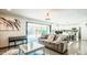 Bright living room featuring a comfortable couch, stylish decor, and sliding glass doors to the backyard at 11215 N 37Th Ave, Phoenix, AZ 85029