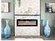 Modern fireplace with stone surround, flanked by blue vases, enhances this inviting living space with stylish decor at 11215 N 37Th Ave, Phoenix, AZ 85029
