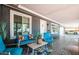 Covered patio with cozy seating, offering a relaxing outdoor living space with view of the garage at 11215 N 37Th Ave, Phoenix, AZ 85029