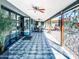 Expansive covered patio featuring tiled flooring, multiple seating areas, and sliding glass doors for seamless indoor-outdoor living at 11215 N 37Th Ave, Phoenix, AZ 85029