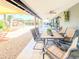 Relaxing covered patio with an outdoor dining area, lounge chairs, and a beautifully landscaped backyard at 11215 N 37Th Ave, Phoenix, AZ 85029