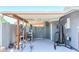Covered outdoor workout area featuring gym equipment, weights, and a punching bag for a complete fitness setup at 11215 N 37Th Ave, Phoenix, AZ 85029