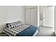 Cozy bedroom featuring a comfortable bed with a patterned comforter, a closet with sliding doors, and soft carpeting at 1130 N 2Nd St # 401, Phoenix, AZ 85004