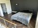 A modern bedroom with a black accent wall, sleek bed, and stylish furnishings at 1130 N 2Nd St # 401, Phoenix, AZ 85004
