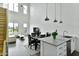 Bright open-concept kitchen and living space featuring high ceilings, large windows, and a crisp, white color scheme at 1130 N 2Nd St # 401, Phoenix, AZ 85004