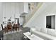 Bright open-concept living space featuring sleek, modern design with hardwood floors, stainless steel railings, and a crisp, white color scheme at 1130 N 2Nd St # 401, Phoenix, AZ 85004