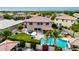 Aerial view of a backyard featuring a pool, spa, manicured lawn, and outdoor kitchen at 1179 E Regent Dr, Gilbert, AZ 85298