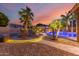 Beautiful backyard features a stone pathway, a cozy fire pit, a pool, and lush landscaping at 1179 E Regent Dr, Gilbert, AZ 85298