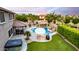 Stunning backyard featuring a custom pool, spa, outdoor kitchen, covered patio, and lush landscaping at 1179 E Regent Dr, Gilbert, AZ 85298