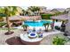 Beautiful backyard with a custom pool, outdoor kitchen, fire pit area, and covered seating at 1179 E Regent Dr, Gilbert, AZ 85298