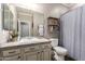 Bathroom featuring a framed mirror, vanity with solid surface countertops, and a shelf for storage and décor at 1179 E Regent Dr, Gilbert, AZ 85298