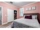 Charming bedroom featuring a closet, shutters, a comfortable bed, neutral tones, and warm lighting for a relaxing atmosphere at 1179 E Regent Dr, Gilbert, AZ 85298