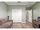 Cozy bedroom with an area rug, double door closet, modern paint and luxury vinyl plank floors at 1179 E Regent Dr, Gilbert, AZ 85298