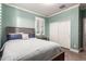 Inviting bedroom featuring light green walls, plantation shutters, wood-look floors, and a cozy ambiance at 1179 E Regent Dr, Gilbert, AZ 85298