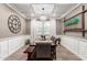 Elegant dining room featuring wainscoting, a modern chandelier, and a large table with seating for eight at 1179 E Regent Dr, Gilbert, AZ 85298