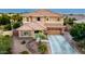 Two-story home with a tile roof, desert landscaping, and a three-car garage at 1179 E Regent Dr, Gilbert, AZ 85298