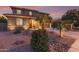 Beautiful two-story home with desert landscape and a charming desert stream feature in the front yard at 1179 E Regent Dr, Gilbert, AZ 85298