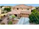 Two-story home featuring a tile roof, desert landscaping, and a three-car garage at 1179 E Regent Dr, Gilbert, AZ 85298