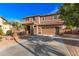 Lovely two-story home with a well-kept front yard, a desert landscape, and a two-car garage at 1179 E Regent Dr, Gilbert, AZ 85298